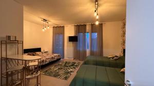 a room with a bed and a table and a couch at COMFORT ACCOMMODATION SUITE in Bergamo