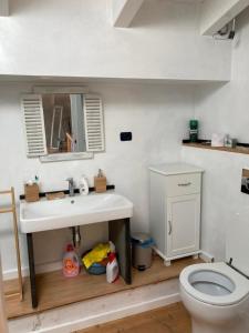 a bathroom with a white sink and a toilet at La Suite Sotto Stelle in Oristano