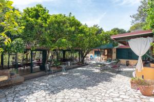 a patio with tables and chairs and a umbrella at B&B La Nave in Naples