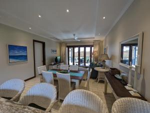 a living room with a table and chairs at Eden Island Apartment Citronelle in Eden Island