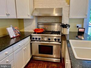 a kitchen with a stainless steel stove and a sink at Vintage Charm: Annapolis Retreat in Annapolis