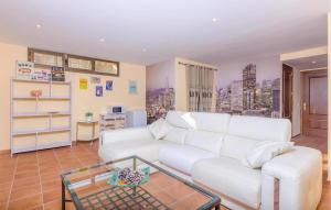 a living room with a white couch and a glass table at 4 Bedroom Cozy Home In Mal Pas, Bonaire in Cielo de Bonaire 