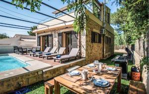 a patio with a table and chairs next to a pool at 4 Bedroom Cozy Home In Mal Pas, Bonaire in Cielo de Bonaire  +23 photos