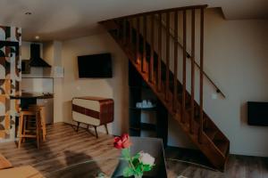 sala de estar con escalera y mesa en Le Central Hôtel-Bar, en Oloron-Sainte-Marie