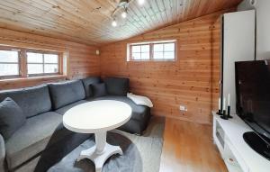 a living room with a couch and a table at 2 Bedroom Awesome Home In Ljungby in Ljungby