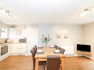 a kitchen and dining room with a table and chairs at The Brambles in Monmouth