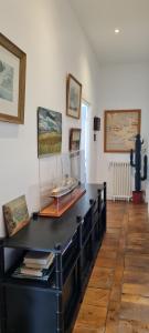 a black counter in a room with paintings on the wall at Manoir du Haut Jussé in Vezin-le-Coquet +2 photos