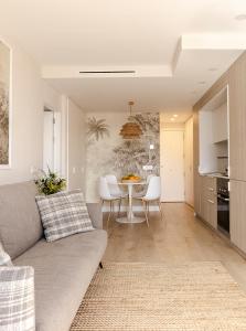 a living room with a couch and a table at Las Canteras con Alma in Las Palmas de Gran Canaria