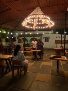 a group of people sitting at tables in a room at Seven Tales in Anjuna