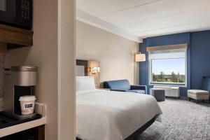 a hotel room with a bed and a window at Holiday Inn Express - Strathroy, an IHG Hotel in Strathroy