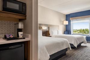 a hotel room with two beds and a window at Holiday Inn Express - Strathroy, an IHG Hotel in Strathroy