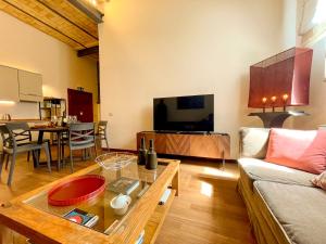 a living room with a couch and a table at Velabro Luxury Loft in Rome