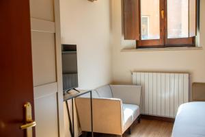 a living room with a couch and a chair at Velabro Luxury Loft in Rome