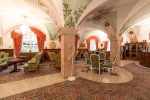 uma sala de estar com arcos e cadeiras e uma mesa em Hotel Dolomiti Schloss em Canazei