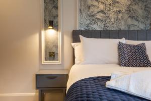 a bedroom with a bed with a blue and white comforter at The Abbeygate Townhouse in Galway