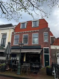 a building with a table and chairs in front of it at Stays by ADM in Leiden