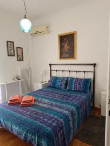 a bedroom with a bed with two towels on it at Panormou studio comfortable max two guests in Athens