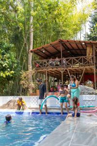 a group of people in a swimming pool at Bahareque Hostal in Ibagué