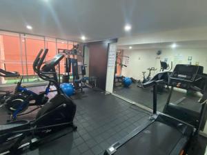 a gym with treadmills and machines in a room at Lovely 1-bedroom apartment at Chapinero's heart in Bogotá