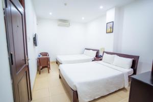 Llit o llits en una habitació de Lotus Rock Hotel Đà Nẵng