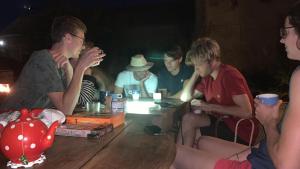a group of young men sitting around a wooden table at YXIE - Manoir des Arts in Villeblevin