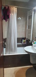 a bathroom with a white shower curtain and a sink at LUX & VIP apartment at Berges du Lac 2 Tunis in La Goulette