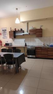 a kitchen with a table and chairs and a stove at Henrix in Warsaw