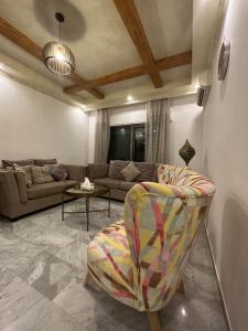 a living room with a couch and a chair at 3bedroom apart at-Al Kursi in Amman
