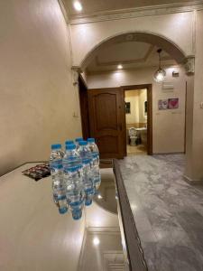 a group of water bottles on a counter in a room at 3bedroom apart at-Al Kursi in Amman