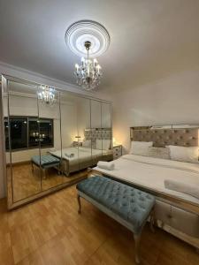 a large bedroom with a large bed and a chandelier at 3bedroom apart at-Al Kursi in Amman