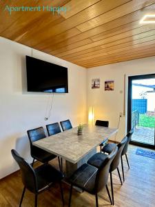 a dining room with a table and chairs at Apartment Happy in Homburg