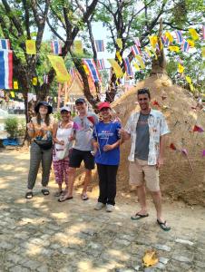 a group of people posing for a picture with flags at Peekaboo house in Ubon Ratchathani