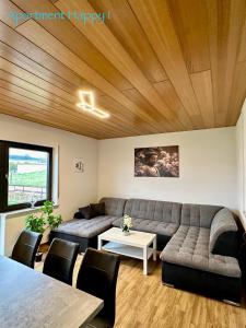 a living room with a couch and a table at Apartment Happy in Homburg