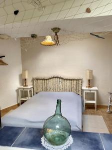 a bedroom with a bed and a vase on a table at FincaOase-Can-Negre-Son-Macia-App-Petit in Son Macia