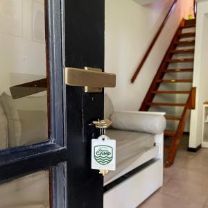 a door with a tag on it next to a staircase at Aparts Laguna Camp in Chascomús