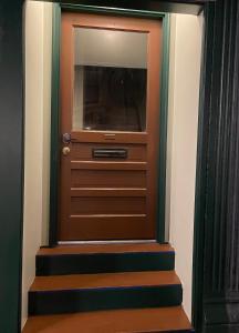 a brown door with stairs in a room at MI CASA in Frankfort