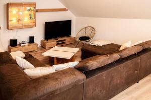 a living room with a large couch and a television at Haus Tanja in Freudenstadt