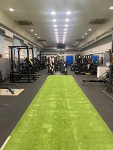 a gym with a green carpet in the middle at LH Hotel Excel Roma Montemario in Rome