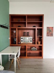 a living room with a microwave and a table at 綠色的日子 in Nantou City