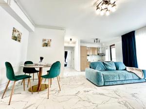 a living room with a couch and a table and chairs at LUXURY Residence 2 bed-room Apartment in Mamaia