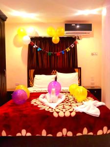 a room with a bed with balloons on it at Pyramids MAGIC INN in Cairo