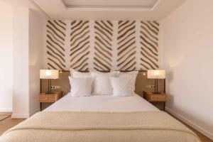 En eller flere senger på et rom på Ksar Char-Bagh Small Luxury Hotels