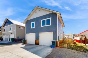 a gray house with two white garage doors at Western Slope Retreat in Gunnison