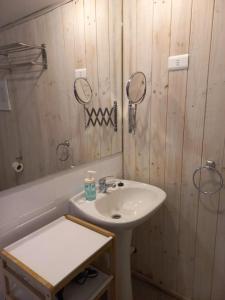 a bathroom with a sink and two mirrors on the wall at Lodge Andes in Farellones