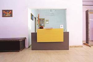 a counter in a room with a yellow and brown at Twamev Punjabi Bagh in New Delhi