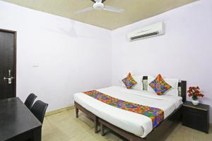 a bedroom with a bed in a room with a ceiling at Twamev Punjabi Bagh in New Delhi