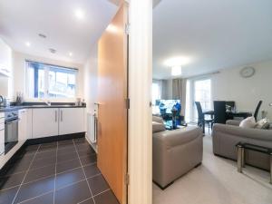 a kitchen and a living room with a couch at Pass the Keys Modern 2 bedroom and 2 Bath Apartment in London in Edgware