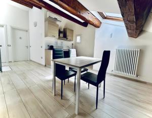 a dining room table and chairs in a room at Centro Storico Suites in Ferrara