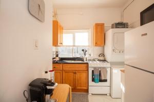 a kitchen with a white refrigerator and a sink at Cozy 1Bed, 1Bath in Brookline, MBTA in Brookline