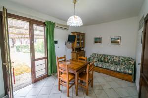 ein Wohnzimmer mit einem Tisch und einem Sofa in der Unterkunft Agriturismo Bio Femminella in Principina a Mare